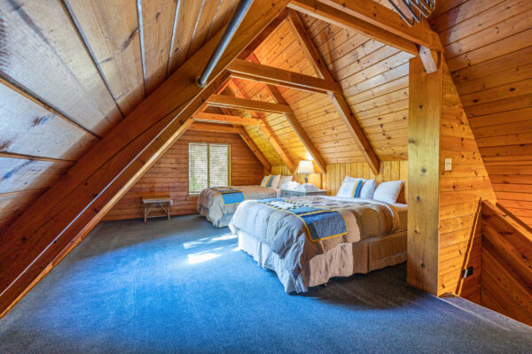 elm cabin loft bedroom with skylights and two queen beds