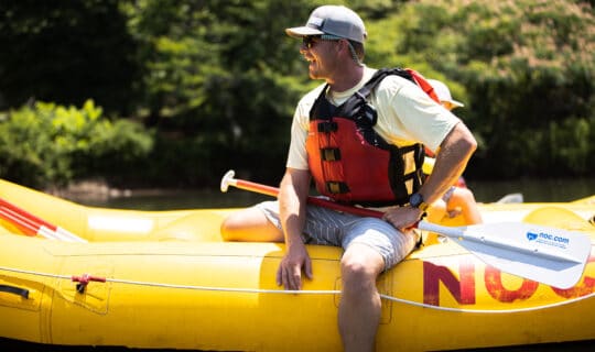 Man sit on a raft on the chattahoochee river