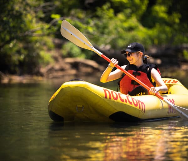 Young woman paddling single ducky on the chattahoochee