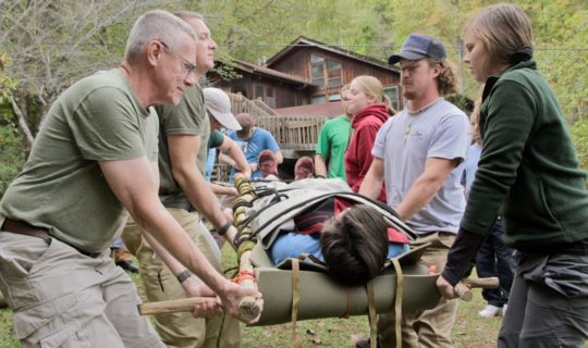 Carrying a person on a stretcher during the Advanced Wilderness First Aid (AWFA) Certification Course