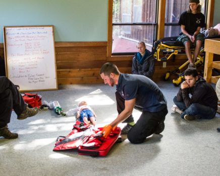 Man practicing CPR on a doll during the ASHI CPR and AED Certification Course