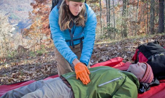 woman doing cpr on a man during the AWFA-WFR Bridge Course