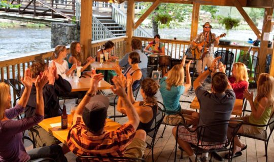 Diners listening to live music at Big Wesser Riverside Pub