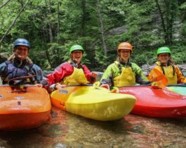 Four guests in kayaks on the Chattachoochee River- Intro to Whitewater Kayaking Trip