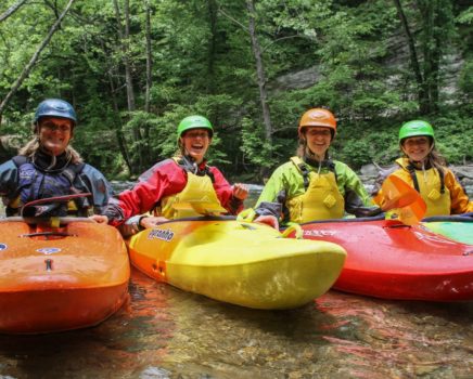 Four guests in kayaks on the Chattachoochee River- Intro to Whitewater Kayaking Trip