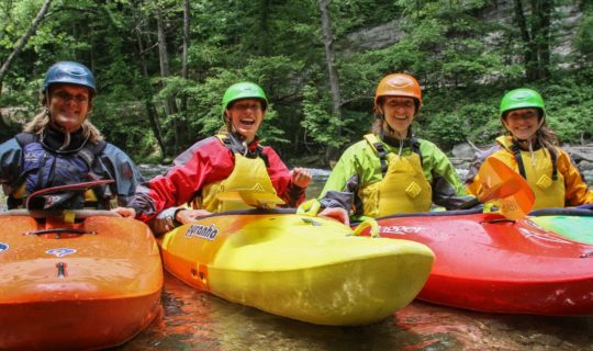 Four guests in kayaks on the Chattachoochee River- Intro to Whitewater Kayaking Trip