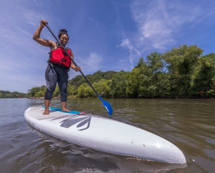 Woman stand up paddleboarding on the Chattahoochee River Stand Up Paddleboard Rentals (SUP) – Roswell trip