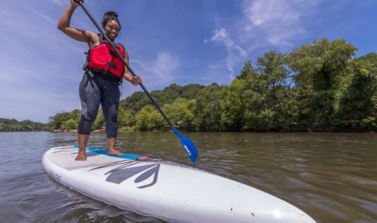 Woman stand up paddleboarding on the Chattahoochee River Stand Up Paddleboard Rentals (SUP) – Roswell trip