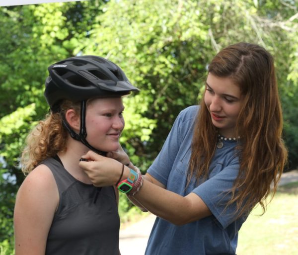 Buckling a girl's helmet on the Chattahoochee River Bike Rentals – Roswell trip