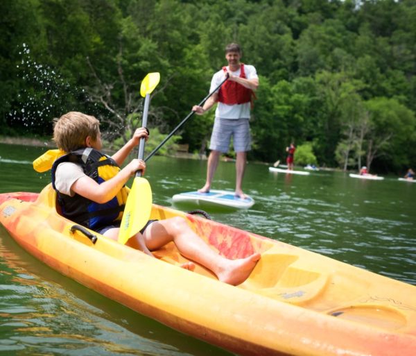 Kid splashing water on the Fontana Lake Kayak & SUP Rentals trip