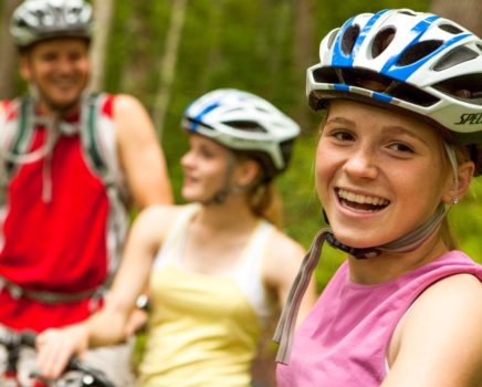 Three mountain biking guests smiling
