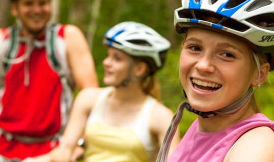 Three mountain biking guests smiling