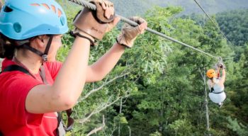 Guest on zip line on the Mountaintop Zip Line Tour