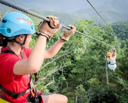 Guest on zip line on the Mountaintop Zip Line Tour