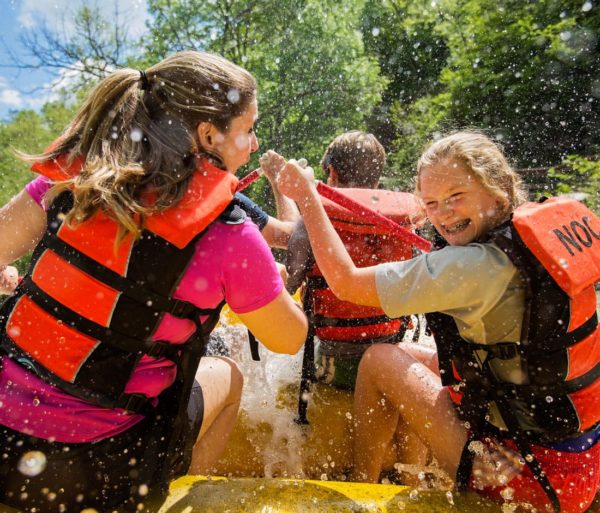 Girls getting splashed while rafting on the Nantahala River Rafting: Fully-Guided in North Carolina trip