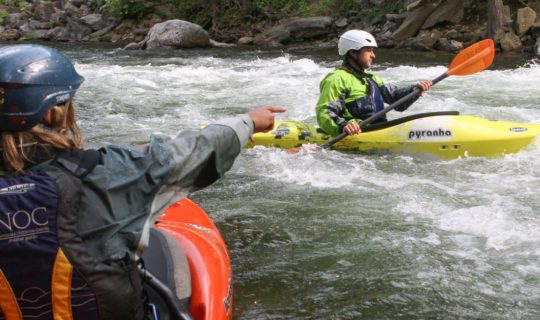 Instructor pointing to where guest should kayak on the Private Canoe and Kayak Instruction course