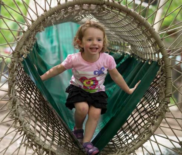 Girl playing on the Treetop Adventure Nets