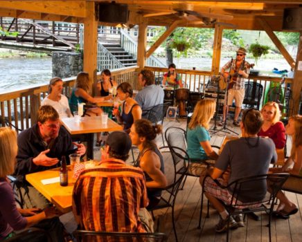 people enjoying music and food at Big Wesser Riverside Pub