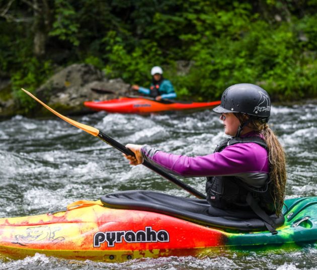 Kayaker on a river during Advanced Teen Kayak Camp