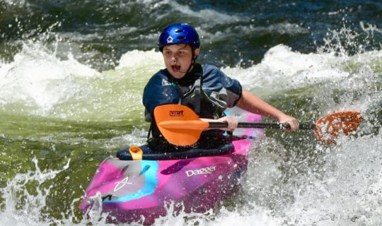 Kayaker on a river during Advanced Teen Kayak Camp