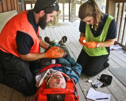 Putting bandages on a person during the Wilderness EMT Intensive / EMT Basic / Wilderness Module course