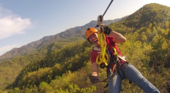 Guest on zip line on the Mountaintop Zip Line Tour