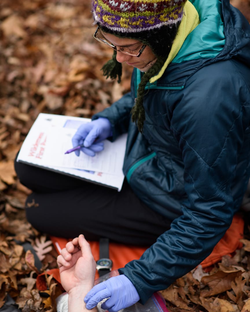 Taking blood pressure while on the Wilderness Medicine (SOLO Southeast) course