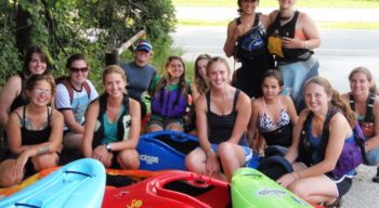 Group of women by kayaks on the Women's Weekend Kayak Retreat