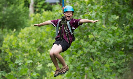 Boy zip lining