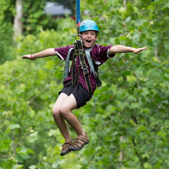 Boy zip lining