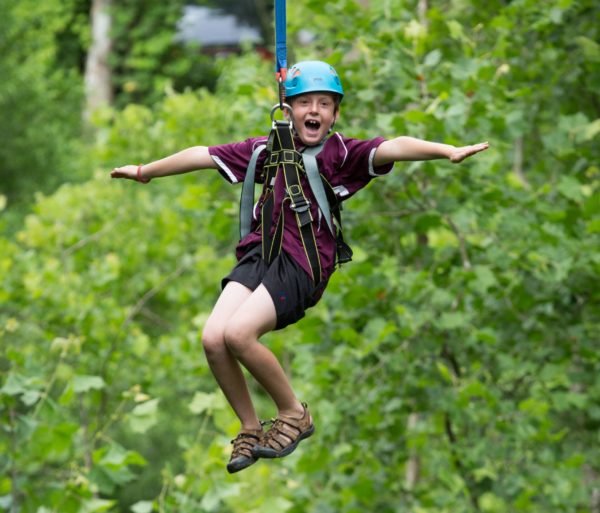 Boy zip lining