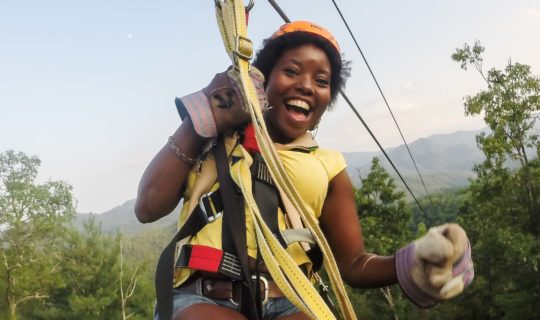 Guest on zip line on the Mountaintop Zip Line Tour