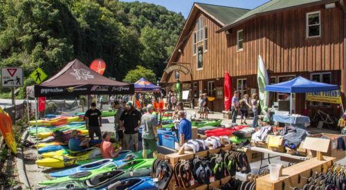 guests standing outside looking at canoe