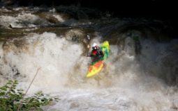 kayak going down river cascade
