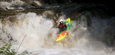 kayak going down river cascade