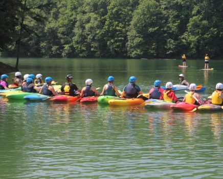 Group of colorful kayakers learning to kayak on the Introduction to Kayaking Course – Chattahoochee River course