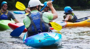 Group of colorful kayakers learning to kayak on the Introduction to Kayaking Course – Chattahoochee River course