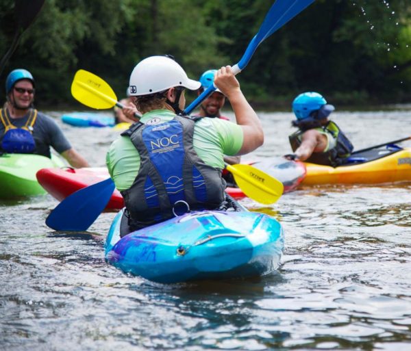 Group of colorful kayakers learning to kayak on the Introduction to Kayaking Course – Chattahoochee River course