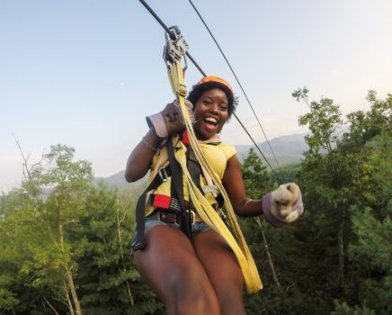Guest on zip line on the Mountaintop Zip Line Tour