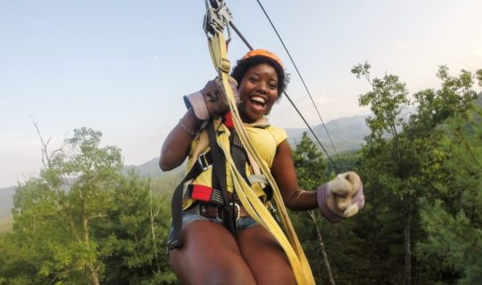 Guest on zip line on the Mountaintop Zip Line Tour