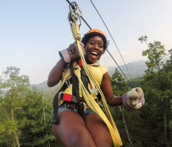 Guest on zip line on the Mountaintop Zip Line Tour