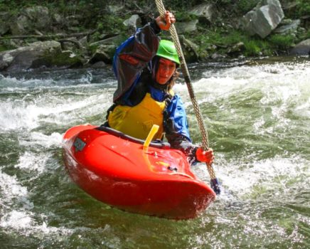Person kayaking on class 2 rapids