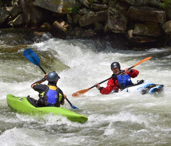 2 people kayaking through class 3 rapids