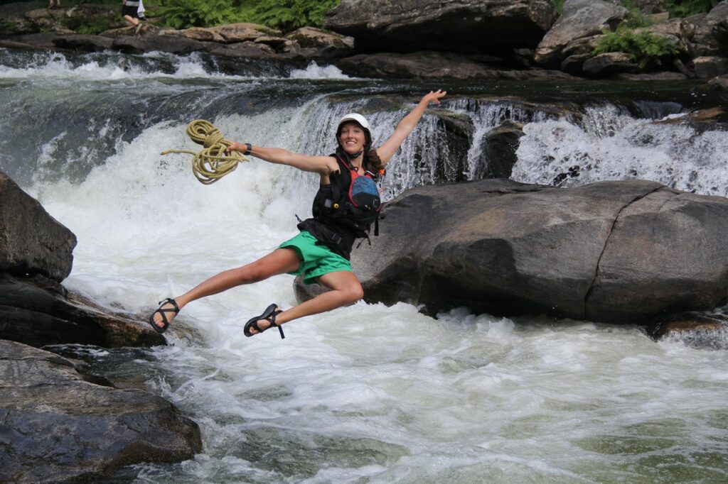 Isabel Blue, NOC Guide jumping into the Chattooga
