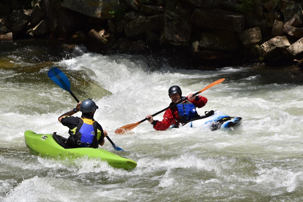 2 kayakers in Class III rapids