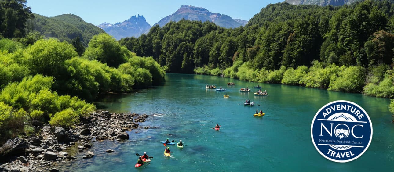 kakayers and rafters paddle the blue waters of the futaleufu river amongst towering green mountains
