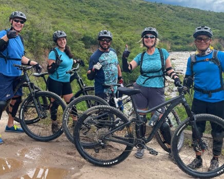 mountain bikers standing side by side in a mountainous region of colombia