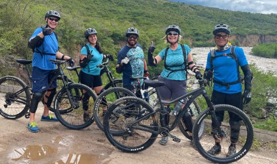 mountain bikers standing side by side in a mountainous region of colombia