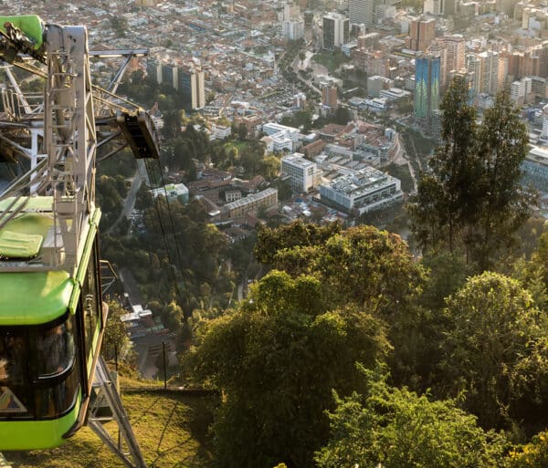 a gondola rides over a cityscape in colombia