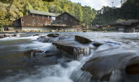 the outfitters store set back behind the nantahala river flowing